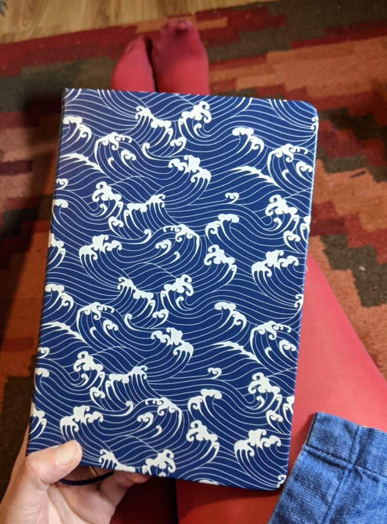 Hardback notebook with a cover pattern of blue and white waves