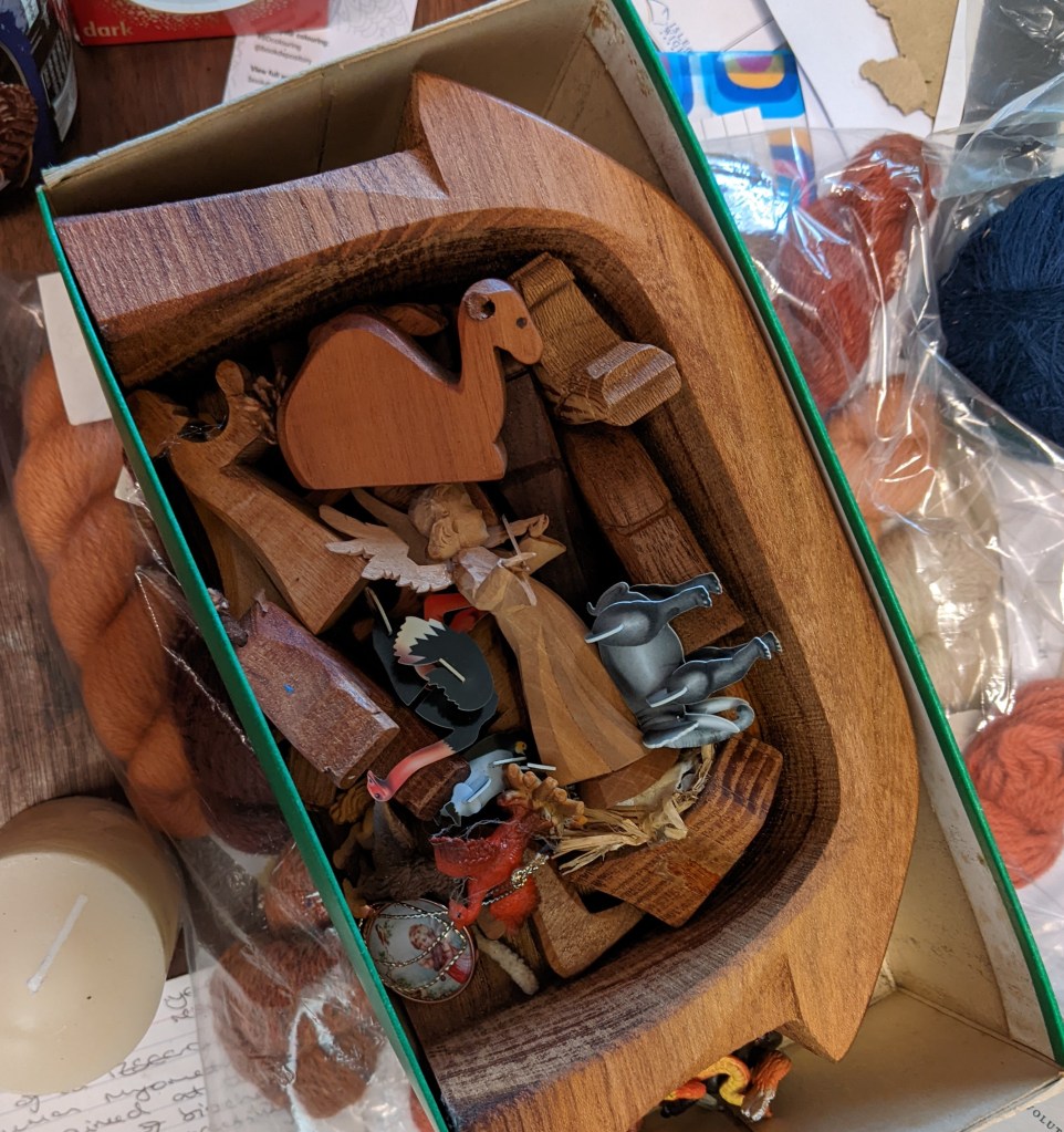 olive wood Nativity crib scene, with the stable on its back in a shoebox and the figures within it, plus some other items including a plastic elephant, ostrich and phoenix