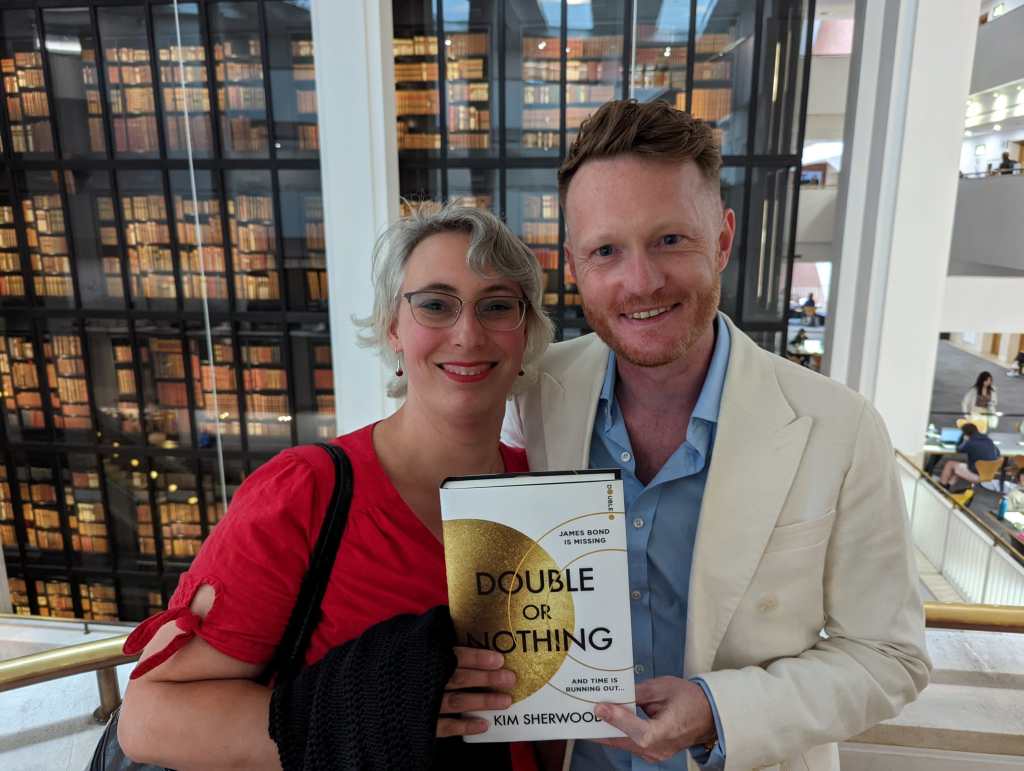 A woman and a man hold up a copy of Double Or Nothing