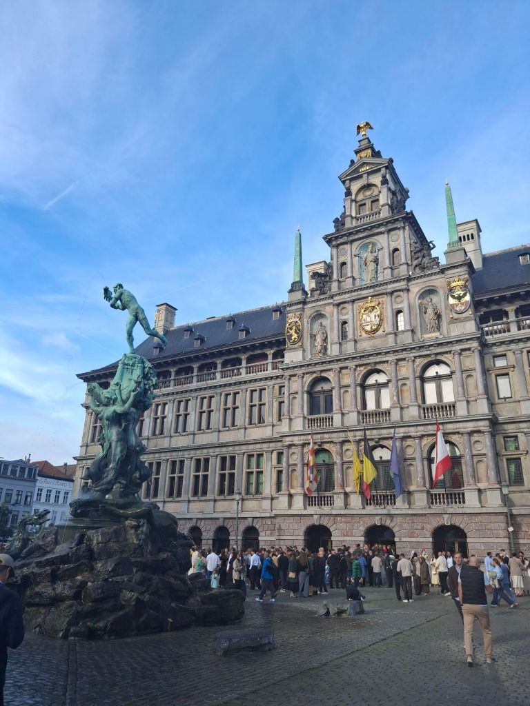 An elaborate fountain in a crowded square